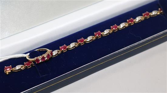 A modern 9ct gold, ruby and diamond set ring and a similar bracelet.